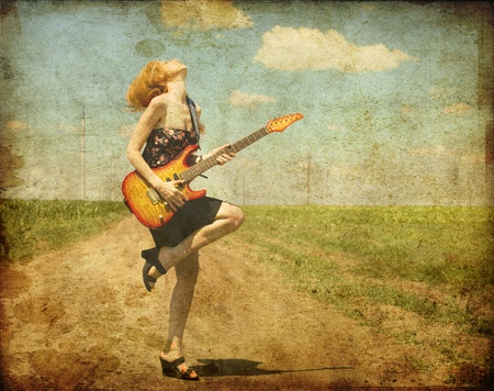 10690262 - rock girl with guitar at countryside. photo in old color image style.
