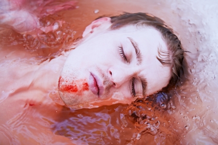 17994412 - dead man's face with a bloody wound in water closeup