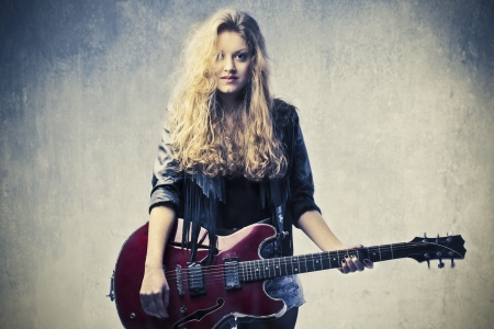 15264032 - blonde girl playing electric guitar